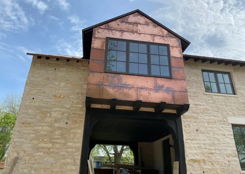 Copper metal panel facade on a stone building for Skylight Installation in Spout Springs