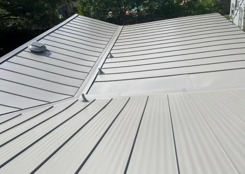 Solar attic fan installed on a metal roof for Roof Ventilation in Spout Springs